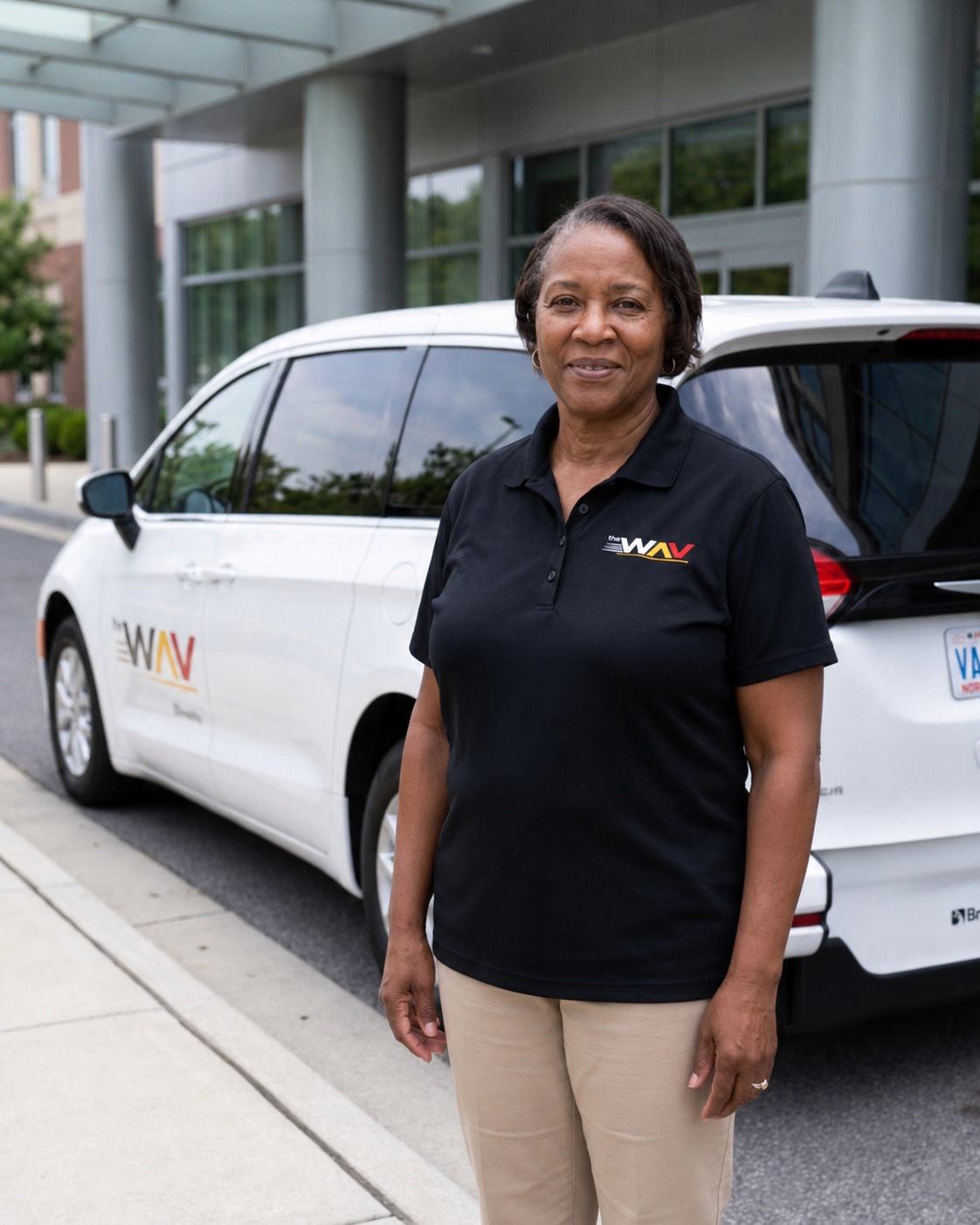 Professional The Wav driver beside branded vehicle